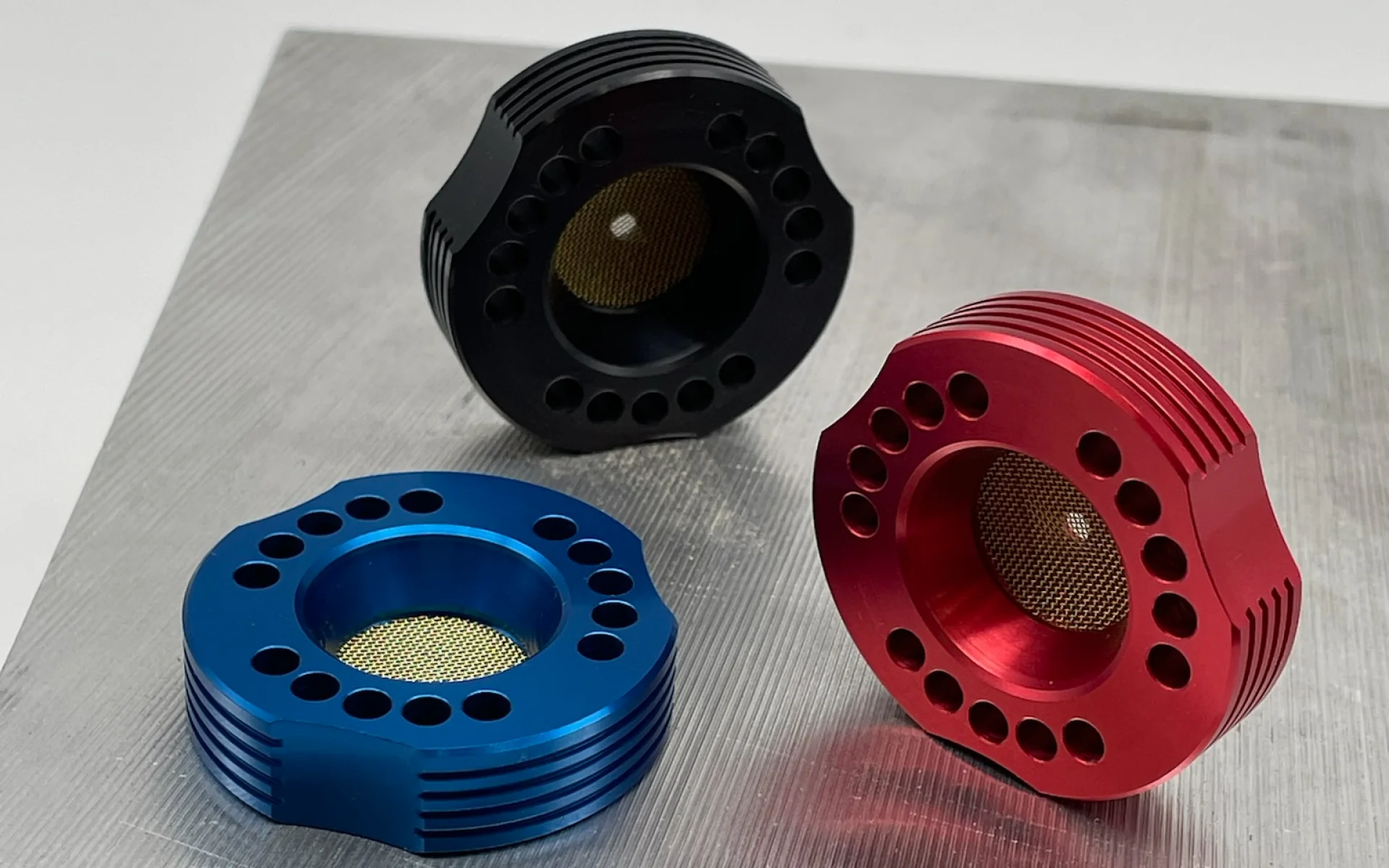 Anodized aluminum bowls in black, blue, and red colorways